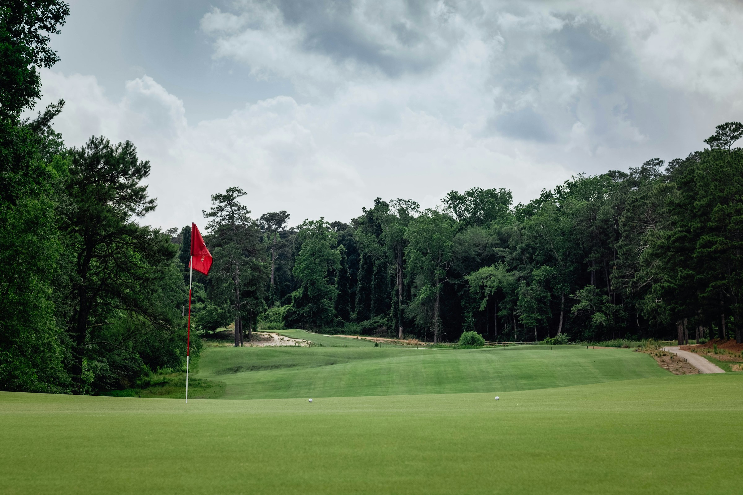 A golf green with a red flagstick on a North Carolina course
