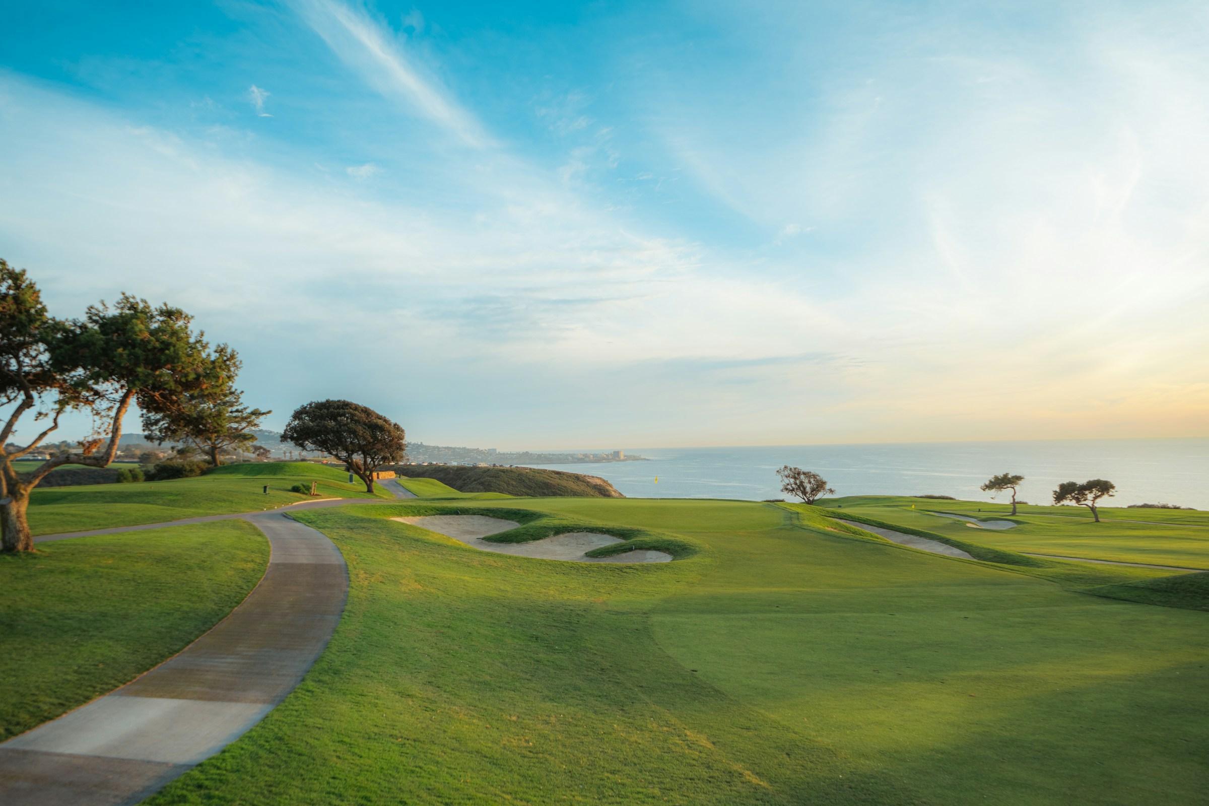 A fairway path leading toward a body of water