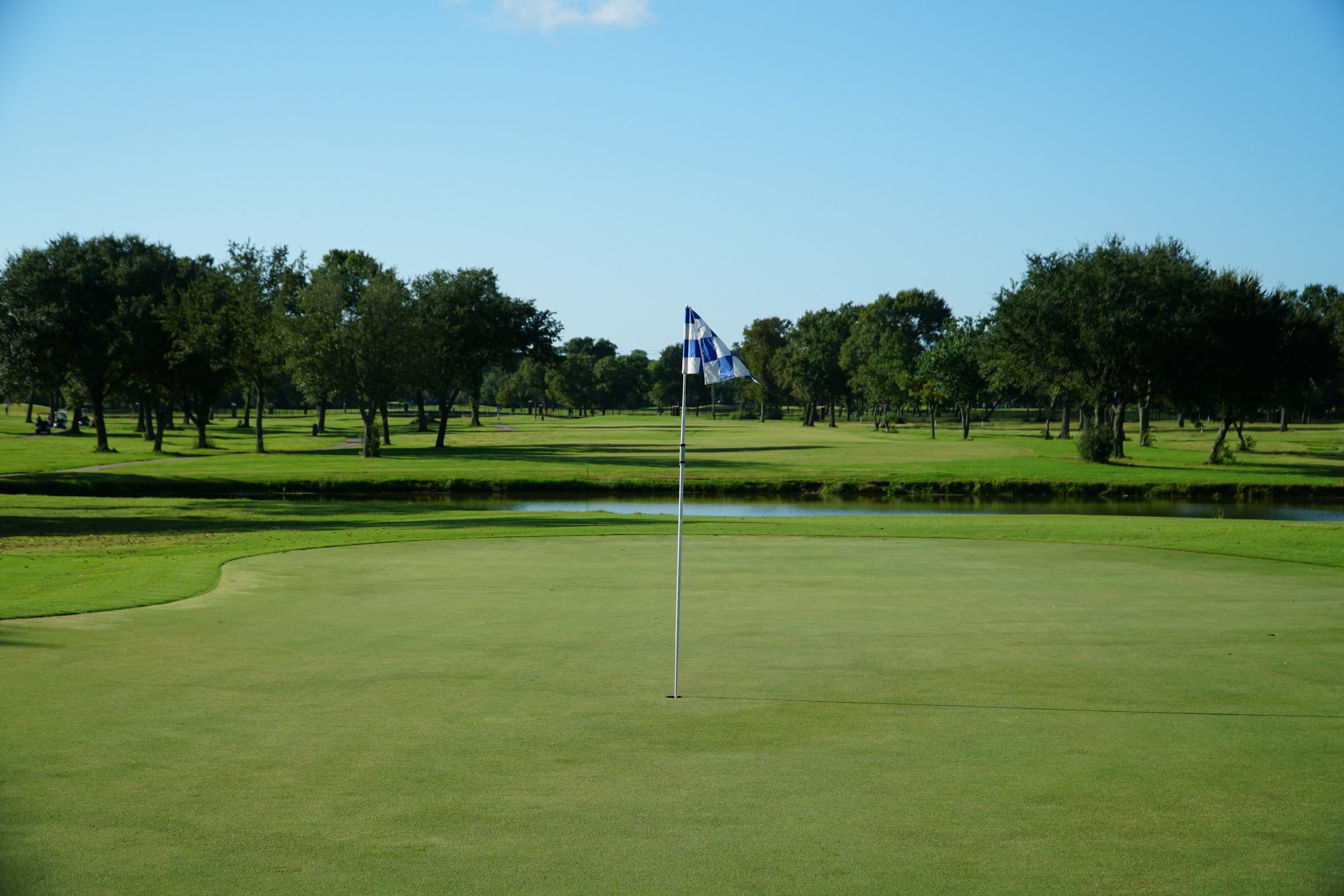 A well-maintained fairway with trees in the distance on a Texas course