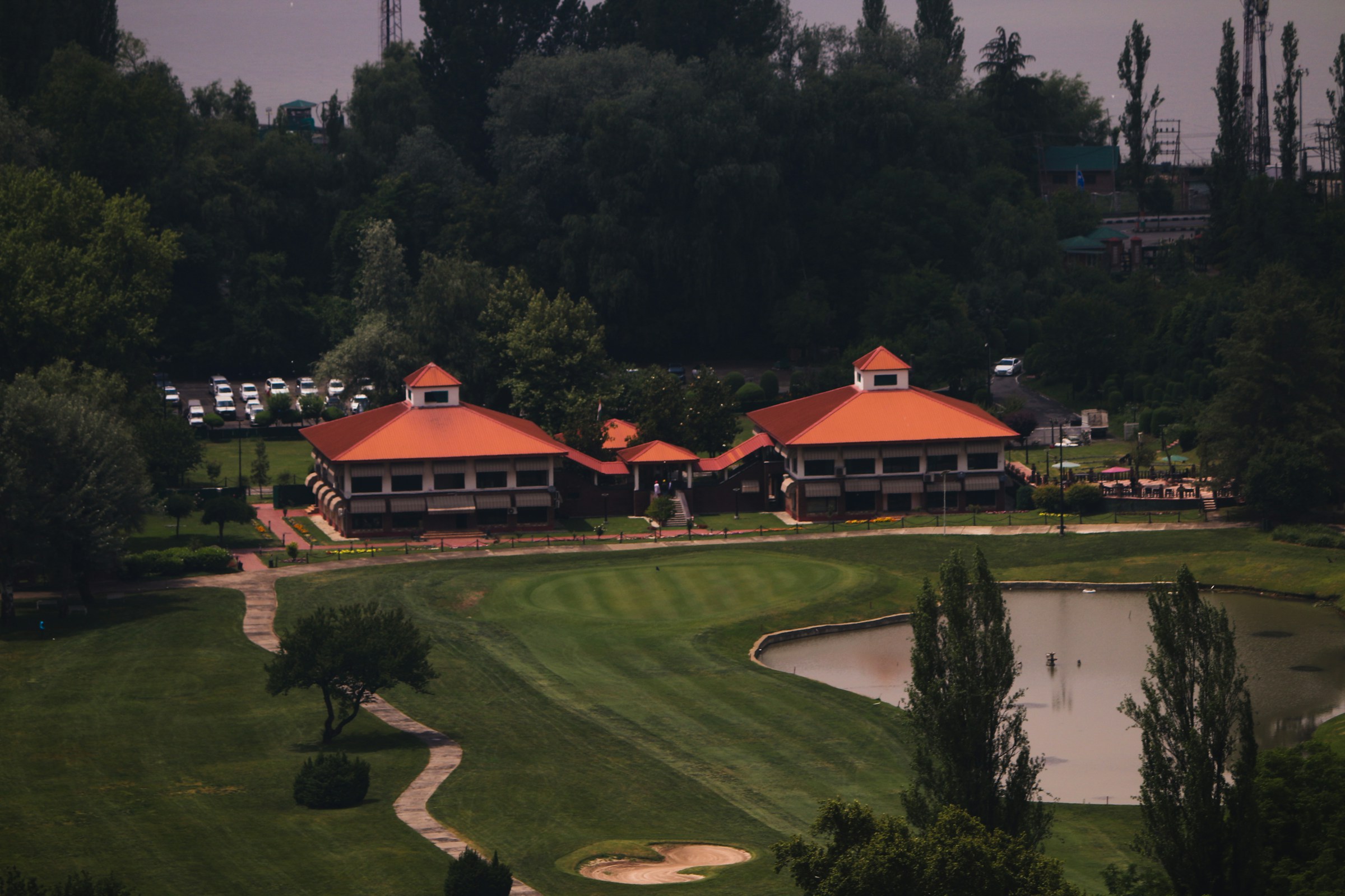 A golf clubhouse and pond at a resort-style course